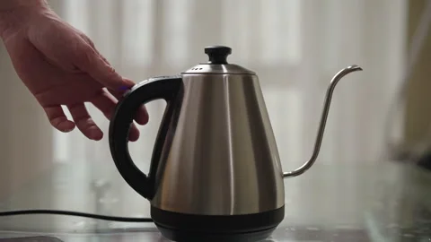 Close-up side view of man adjusting digital controls, starting water boiling Stock Footage 306700904