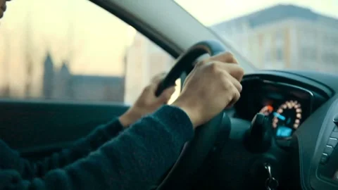 Close up side view of man keeping hand on the steering wheel while driving a Video stock 336266472