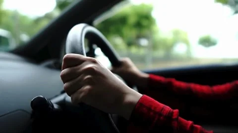 Close up side view of man keeping hand on the steering wheel while driving a Stock Footage 336266993