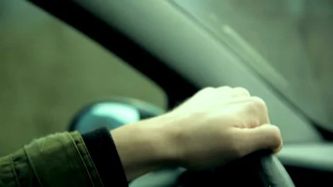 Close up side view of man keeping hand on the steering wheel while driving a Stock-Footage 336267088