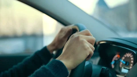 Close up side view of man keeping hand on the steering wheel while driving a Stock-Footage 336267237