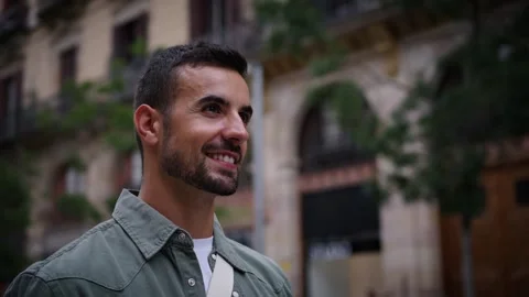 Close up side view millennial bearded attractive man walking smiling in European Stock Footage 266825351