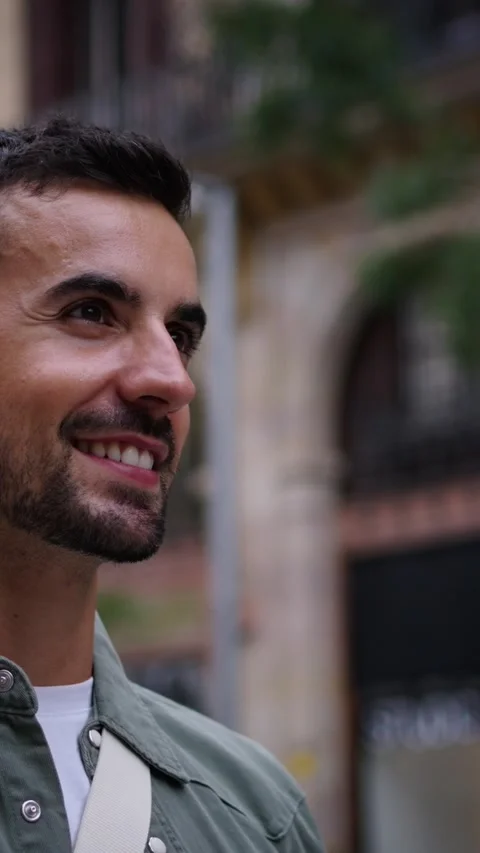 Close up side view millennial bearded attractive man walking smiling in European Stock Footage 267485338