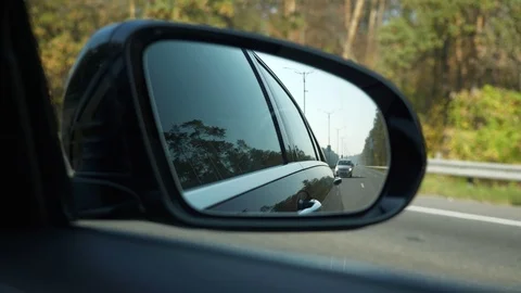 Close-up Side-view mirror Reflection Car Moving Behind Following on Highway. Bri Stock Footage 106188810