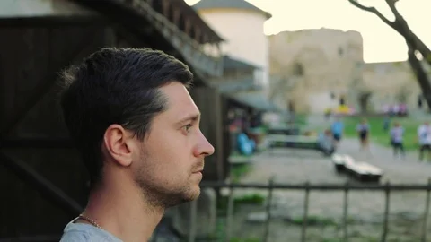 Close up side view of nervous anxious man putting red apple on his head as 스톡 동영상 108726855