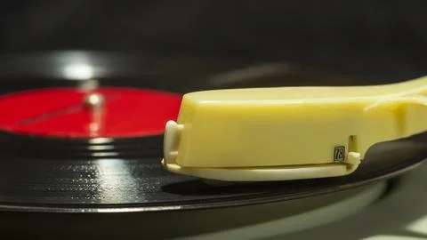 Close up side view of old vinyl record spinning on old turntable player with  Stock Photos