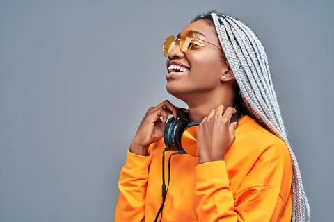 Close up side view portrait of afro american woman with sunglasses listening  Stock Photos