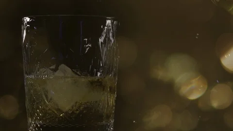 Close-up. Side  VIew of Pouring Glass of Whiskey. Video stock 124540333