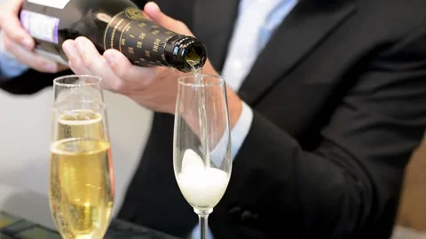 Close up side view of pouring sparkling wine or champagne into glass Stock Footage 167222125
