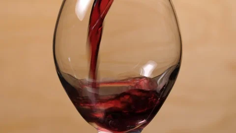 Close up side view of red wine being poured into glass in 4k. Stock Footage 86536689
