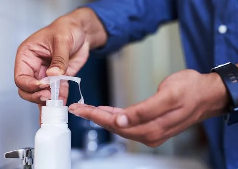 Close up side view of soap being dispensed in the bathroom Stock Photos