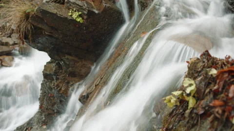 Close up side view of speedy flow of pure water moving down rocky slope, autumn Stock Footage 256297738