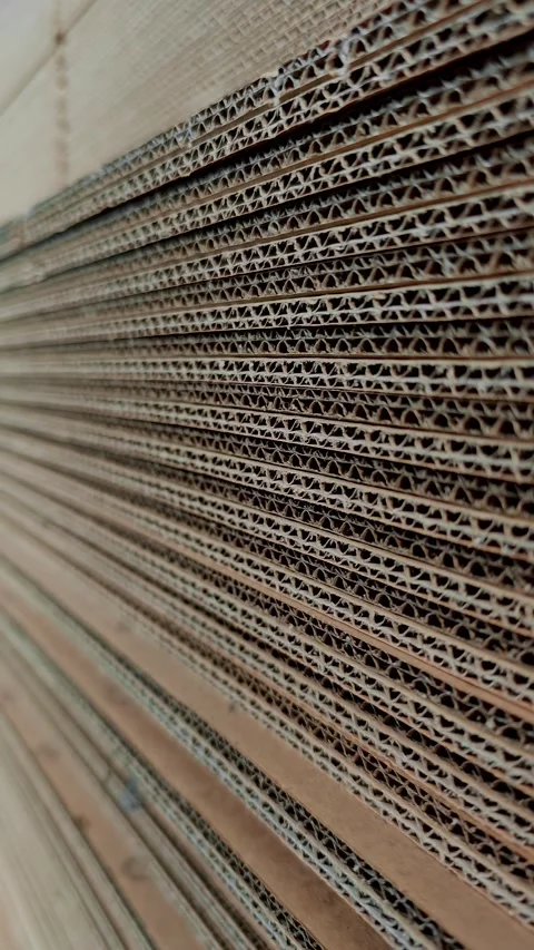 Close up side view of stacked corrugated cardboard sheets in factory Stock Footage 346247944