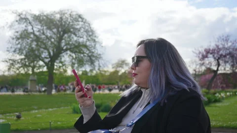 Close-up side view of stylish plus size female with dyed purple hair typing Stock Footage 241420542