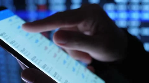 Close up side view trader holding cellphone in broker media trading stock m.. Stock Footage 272778973