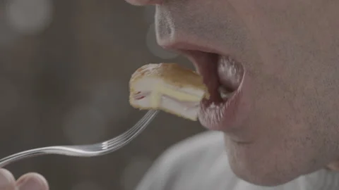 Close-up side view unidentified cheerful man sniffing smiles and eating meat Stock-Footage 143090451