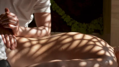 Close-up side view of unrecognizable man having massage in spa salon lying on Video stock 242667985