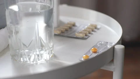Close-up side view of unrecognizable sick young woman takes blister of pills Stock Footage 236985046