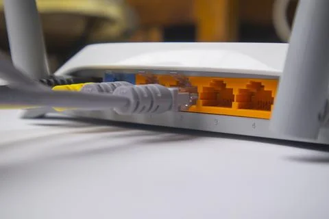 Close-up side view of a white wireless router back panel showing multiple E.. Stock Photos