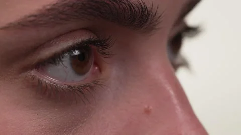Close up side view of a white woman's eyes concentrating on something. Stock Footage 197411383