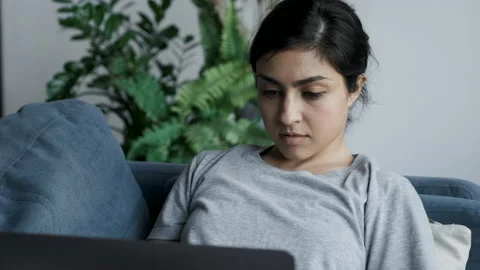 Close Up Side View Young Indian Woman at Home Sitting on a Couch Works Stock Footage 155761285
