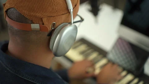 Close up side view of young musician man wearing headphone enjoy playing piano. Stock Footage 282794997