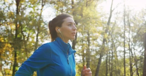 Close up from the side of young sporty pretty woman in blue sweater and with Stock Footage 82501985