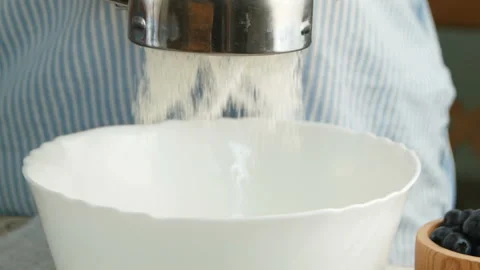 Close-up sifting flour slow motion Video stock 113815969