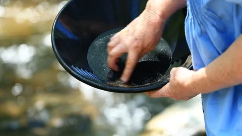 Close Up Sifting through Gold Pan on River - Shallow Depth of Field Stock Footage 114794960