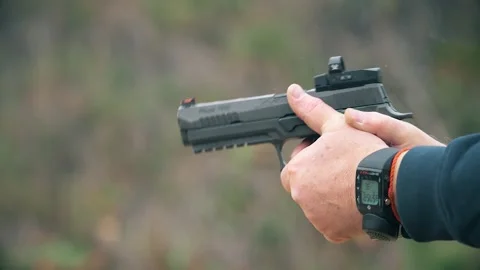 Close-up of a SIG Sauer P320, a semi-automatic pistol, being fired. Stock Footage 303762633