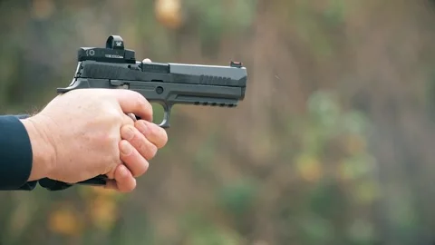 Close-up of a SIG Sauer P320, a semi-automatic pistol, being fired. Stock Footage 303804058