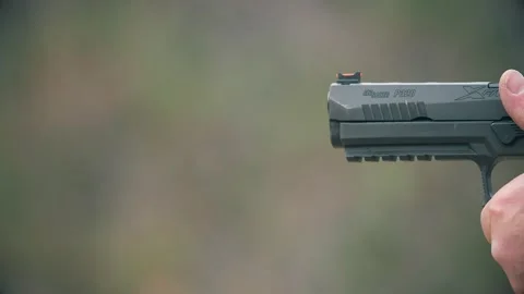 Close-up of a SIG Sauer P320, a striker semi-automatic pistol, being fired. 스톡 동영상 303762638