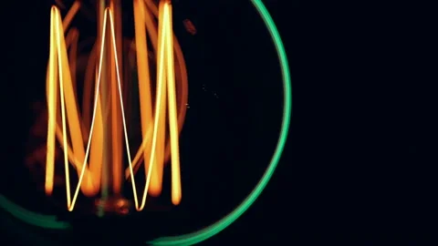 Close up silhouette of a glowing light bulb in the dark. Stock Footage 146370220