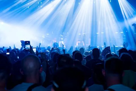 Close up of silhouette of hands in the crowd at a summer music concert or Stock Photos