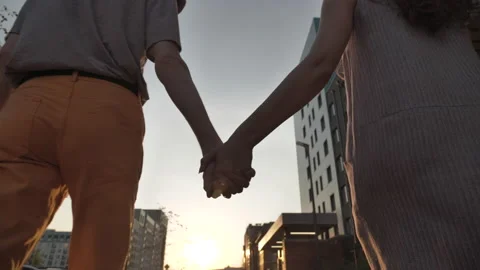 Close-up silhouette of hands holding each other against the sunset sky Stock Footage 135736698
