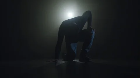 Close-up silhouette of a talented young dancer dancing hip hop street dance on a Stock Footage 111162241