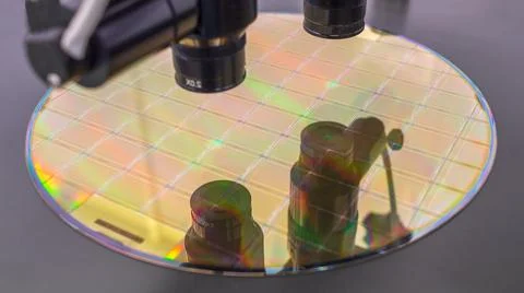 Close up of silicon wafer with microchips on machine process examining in mic Stock Photos