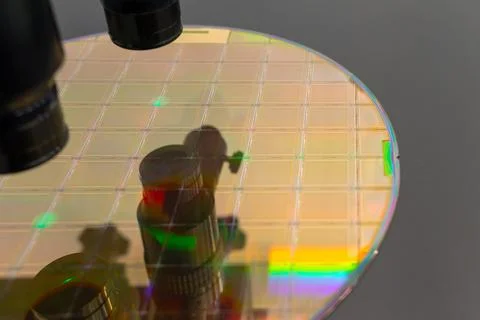 Close up of silicon wafer with microchips on machine process examining in mic Stock Photos
