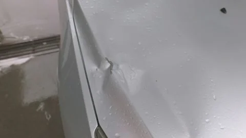 Close-up of Silver Car Fender with Dent and Scratches Stockbeeldmateriaal 334877085