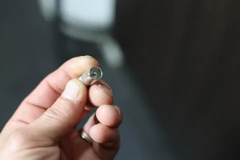 Close-up of a silver coaxial cable connector lying on a textured surface Stock Photos