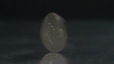 Close up of Silver Dollar spinning lands on heads Stock Footage 114261140