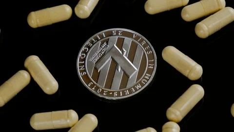 Close up of silver litecoin with tablets rotating on the black background Stock Footage 88224783