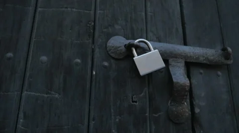 Close up of a silver lock on an old wooden door Video stock 63607752