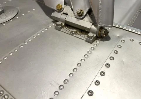 Close-up of silver metal machine with rivets, bolts and hinges Stock Photos