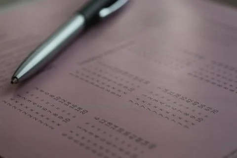 Close-Up of Silver Pen on Pink Document with Code Symbols and Complex Pattern Stock Photos