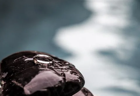 Close-Up Of Silver Ring On Black Wet Natural Stone In Tropics Stock Photos