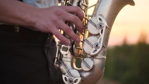 Close up silver sax play by bearded musician in gray shirt performs his part on Stock Footage 157870214