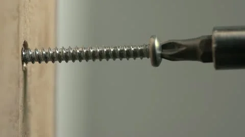 Close up of silver screw being drilled into wood Stock Footage 10944603