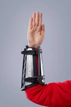 Close-Up of Silver Splinted Bracers on Red Padded Armor. This image shows a.. Stock Photos