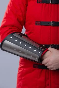 Close-Up of Silver Splinted Bracers on Red Padded Armor. This image shows a.. Stock Photos